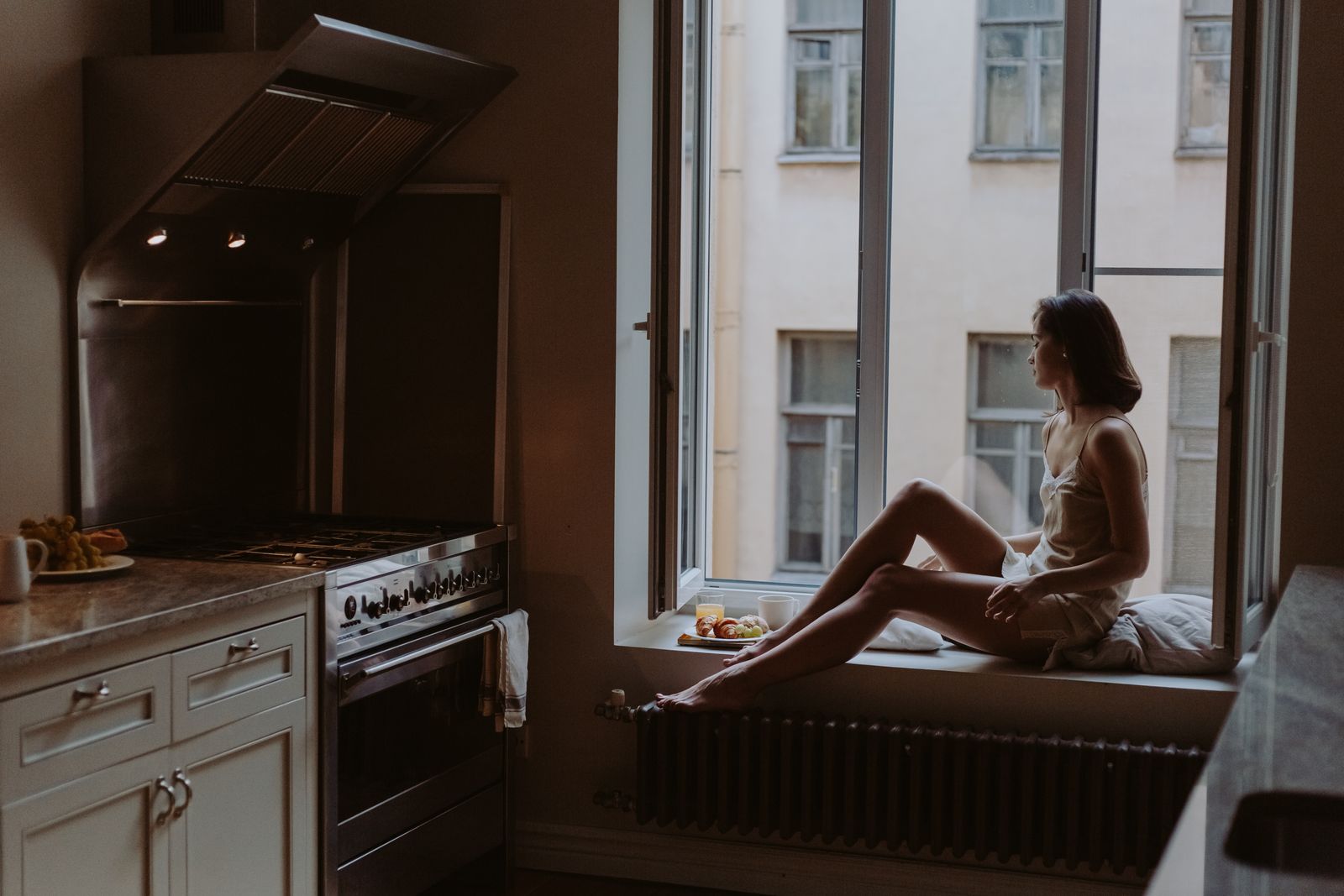 A person sitting quietly beside a window